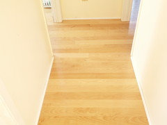 Laying hardwood in hallway and into bedrooms