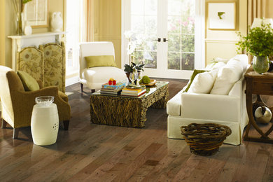 Mid-sized trendy enclosed medium tone wood floor living room photo in Grand Rapids with yellow walls, a standard fireplace and a wood fireplace surround