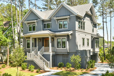 Large transitional gray two-story concrete house exterior idea in Charleston with a mixed material roof