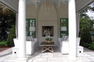 Inspiration for a large transitional backyard stone patio remodel in Charleston with a roof extension