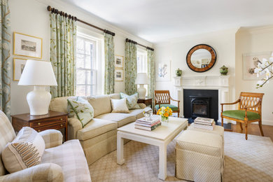 Living room - traditional medium tone wood floor and brown floor living room idea in Boston with white walls and a standard fireplace
