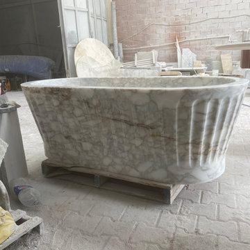 Sculptural Calacatta Gold Marble Bathroom with Hand-Carved Bathtub