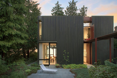 This is an example of a mid-sized contemporary front door in Seattle with a pivot front door and a red front door.