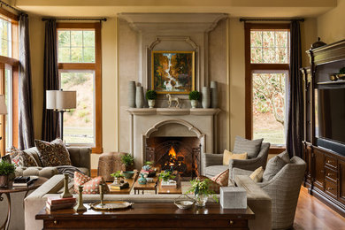Inspiration for a mediterranean medium tone wood floor living room remodel in Portland with yellow walls, a standard fireplace and a media wall