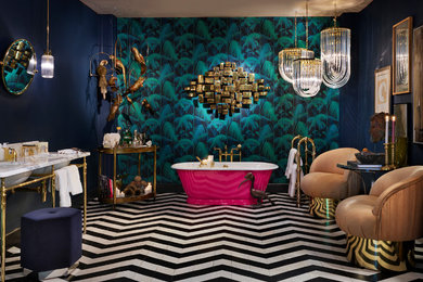 This is an example of an eclectic bathroom in London with a freestanding tub, blue walls, a console sink and black floor.