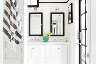 This is an example of a mid-sized scandinavian master bathroom in Los Angeles with recessed-panel cabinets, white cabinets, black and white tile, cement tile, white walls, an undermount sink, marble benchtops, mosaic tile floors and multi-coloured floor.