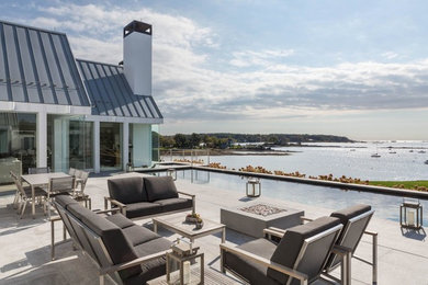Inspiration for a large modern backyard concrete and rectangular lap hot tub remodel in Portland Maine