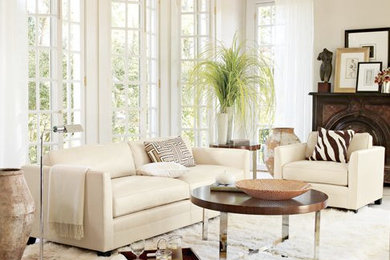 Living room - mid-sized modern formal travertine floor and beige floor living room idea in Orange County with beige walls