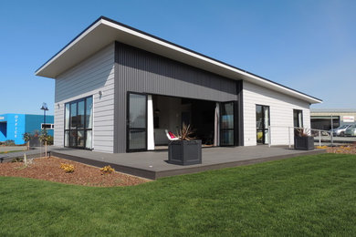 Inspiration for a mid-sized modern one-storey grey exterior in Christchurch with mixed siding.