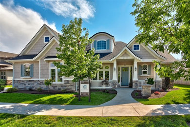 Inspiration for a mid-sized timeless beige one-story mixed siding gable roof remodel in Boise