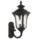 Livex Lighting - Textured Black Traditional, Victorian, Sculptural, Outdoor Wall Lantern - From the Oxford outdoor lantern collection, this traditional cast aluminum upward facing three-light large wall lantern design will add curb appeal to any home. It features a handsome, antique-style wall plate and decorative arm. Clear water glass casts an appealing light and lends to its vintage charm. The wall plate, arm and other details are all in a textured black finish. With superb craftsmanship and affordable price, this fixture is sure to tastefully indulge your senses.