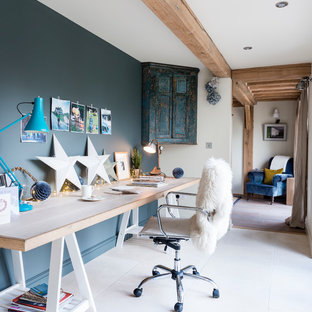 Inspiration for a rustic study in West Midlands with blue walls and a freestanding desk.