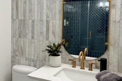 Small transitional 3/4 blue tile and ceramic tile white floor, single-sink and cement tile floor bathroom photo in Seattle with beaded inset cabinets, white cabinets, a two-piece toilet, white walls, an undermount sink, quartz countertops, a hinged shower door, white countertops, a niche and a built-in vanity
