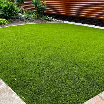 Artificial Grass Edged in Brick Setts and Paving