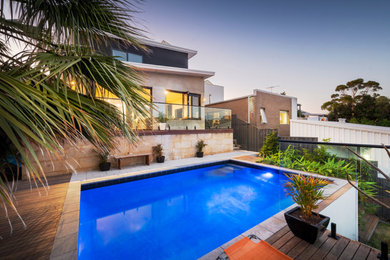 Inspiration for a mid-sized modern backyard rectangular pool in Perth with decking.