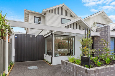 This is an example of a small beach style home design in Melbourne.
