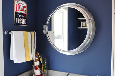Alcove shower - large coastal kids' white tile and subway tile concrete floor alcove shower idea in Vancouver with beaded inset cabinets, white cabinets, a two-piece toilet, blue walls, an undermount sink and quartz countertops