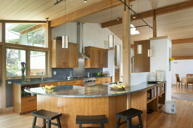 Inspiration for a mid-sized 1960s galley medium tone wood floor open concept kitchen remodel in Denver with a single-bowl sink, shaker cabinets, medium tone wood cabinets, granite countertops, gray backsplash, mosaic tile backsplash, stainless steel appliances and an island
