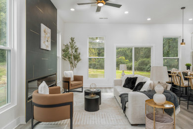 Example of a trendy open concept living room design in Atlanta with white walls and a ribbon fireplace