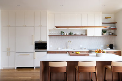 Single-wall medium tone wood floor open concept kitchen photo in San Francisco with an undermount sink, quartz countertops, multicolored backsplash, ceramic backsplash, paneled appliances, an island and white countertops