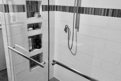 ポートランドにある高級な中くらいなコンテンポラリースタイルのおしゃれな浴室 (コーナー設置型シャワー、白いタイル、セラミックタイル、セラミックタイルの床、グレーの床、引戸のシャワー、ニッチ) の写真