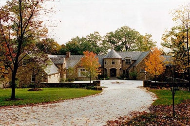 Beige two-story stone exterior home idea in Cleveland with a shingle roof