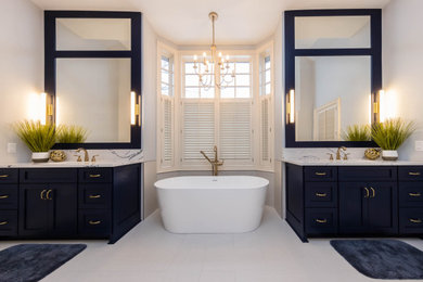 Bathroom - large coastal master blue tile and porcelain tile single-sink, porcelain tile, white floor and wood wall bathroom idea in Columbus with furniture-like cabinets, blue cabinets, quartz countertops, a hinged shower door, white countertops, a built-in vanity, a one-piece toilet, blue walls and an undermount sink