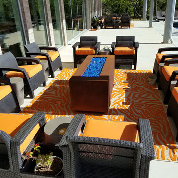 Sunbrella Canvas Tangerine seat cushions pop on luxurious patio