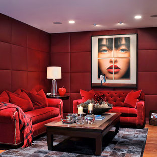 Home theater - contemporary enclosed medium tone wood floor and brown floor home theater idea in Miami with red walls