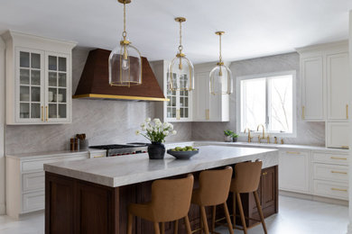Inspiration for a large transitional l-shaped porcelain tile and beige floor eat-in kitchen remodel in DC Metro with an integrated sink, shaker cabinets, brown cabinets, quartzite countertops, beige backsplash, marble backsplash, stainless steel appliances, an island and white countertops