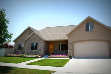 Large beige two-story concrete gable roof idea in Salt Lake City