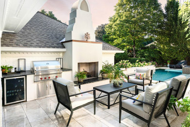 Inspiration for a large backyard patio remodel in Charlotte with a fireplace and a roof extension