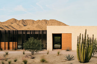 Example of a minimalist one-story stone exterior home design in Phoenix