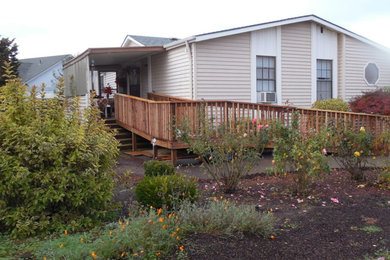 Mid-sized elegant deck photo with an awning