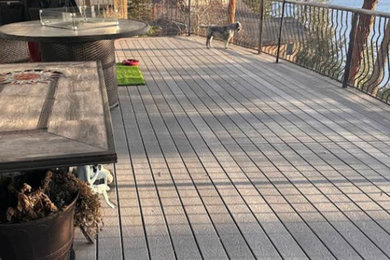 Example of a trendy metal railing deck design in Other