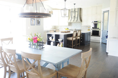 Kitchen - huge farmhouse dark wood floor and brown floor kitchen idea in Baltimore with a farmhouse sink, raised-panel cabinets, white cabinets, quartz countertops, blue backsplash, ceramic backsplash, stainless steel appliances, an island and white countertops