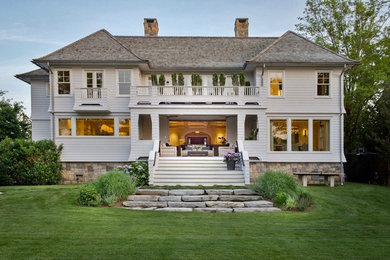 Inspiration for a huge transitional white two-story wood house exterior remodel in Other with a hip roof and a shingle roof