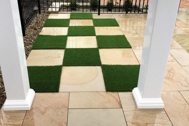 Example of a mid-sized trendy backyard stone and rectangular natural pool design in Cleveland