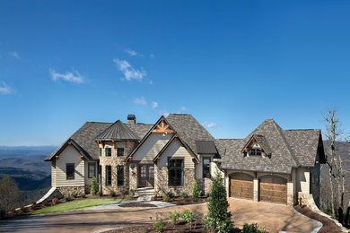 Large traditional brown two-story concrete fiberboard exterior home idea in Other with a mixed material roof