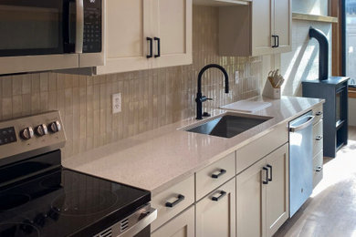 Eat-in kitchen - mid-sized transitional galley medium tone wood floor eat-in kitchen idea in Other with an undermount sink, flat-panel cabinets, white cabinets, quartz countertops, beige backsplash, porcelain backsplash, stainless steel appliances and white countertops