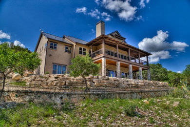 Large elegant beige three-story mixed siding gable roof photo in Austin
