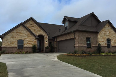 Large elegant multicolored two-story mixed siding house exterior photo in Austin