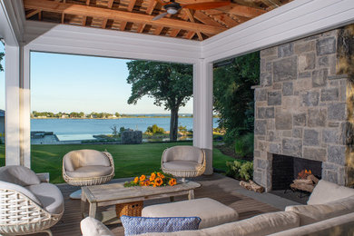 Deck - modern backyard deck idea in Other with a fireplace and a pergola