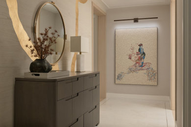 Mid-sized trendy marble floor and brown floor entryway photo in New York with beige walls