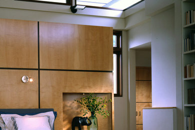 Example of a large trendy master carpeted and blue floor bedroom design in New York with beige walls and no fireplace