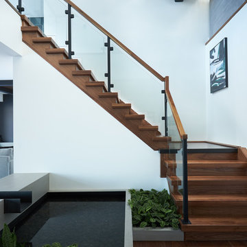 Steel and Concrete Mono Stringer with Clamped Glass Railing System