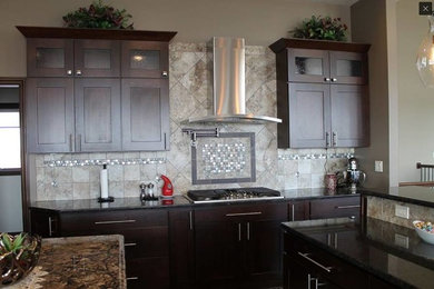 Example of a mid-sized classic u-shaped dark wood floor and brown floor open concept kitchen design in Other with an undermount sink, shaker cabinets, dark wood cabinets, stainless steel appliances, an island, granite countertops, beige backsplash and ceramic backsplash