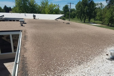Urban flat roof photo in Denver with a mixed material roof