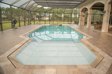 Inspiration for a large modern backyard stone and custom-shaped infinity pool remodel in Miami
