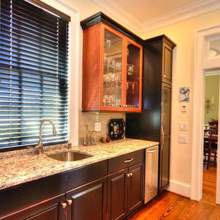 Small traditional kitchen pantry designs - Kitchen pantry - small traditional u-shaped medium tone wood floor and brown floor kitchen pantry idea in Wilmington with an undermount sink, raised-panel cabinets, black cabinets, quartz countertops, beige backsplash, glass tile backsplash and stainless steel appliances